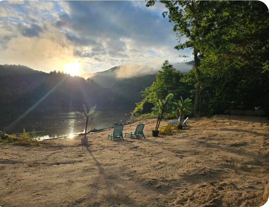 Sunrise god-rays through mountain mist over the beach