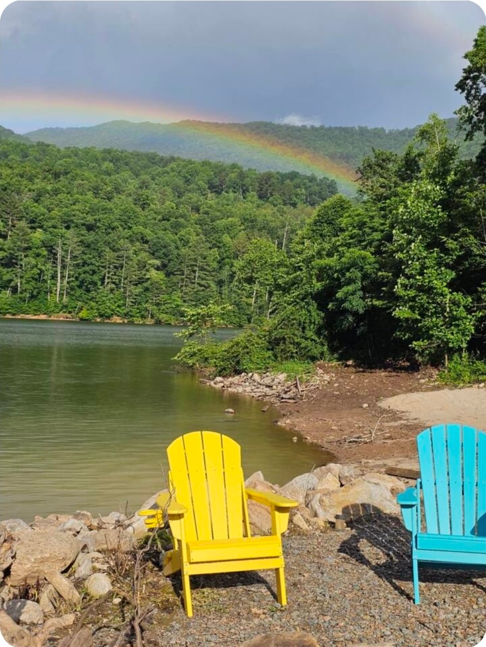 Panoramic view from the knoll overlooking the lake, rainbow over the mountains