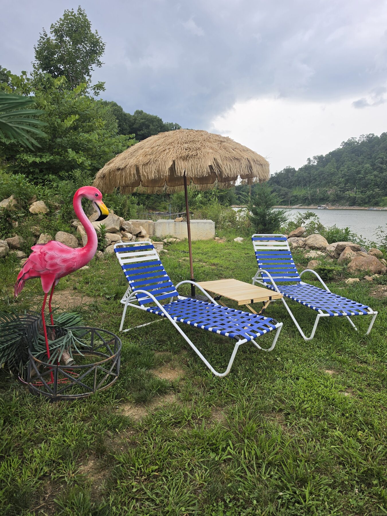 Thatched beach umbrella and loungers at the water's edge