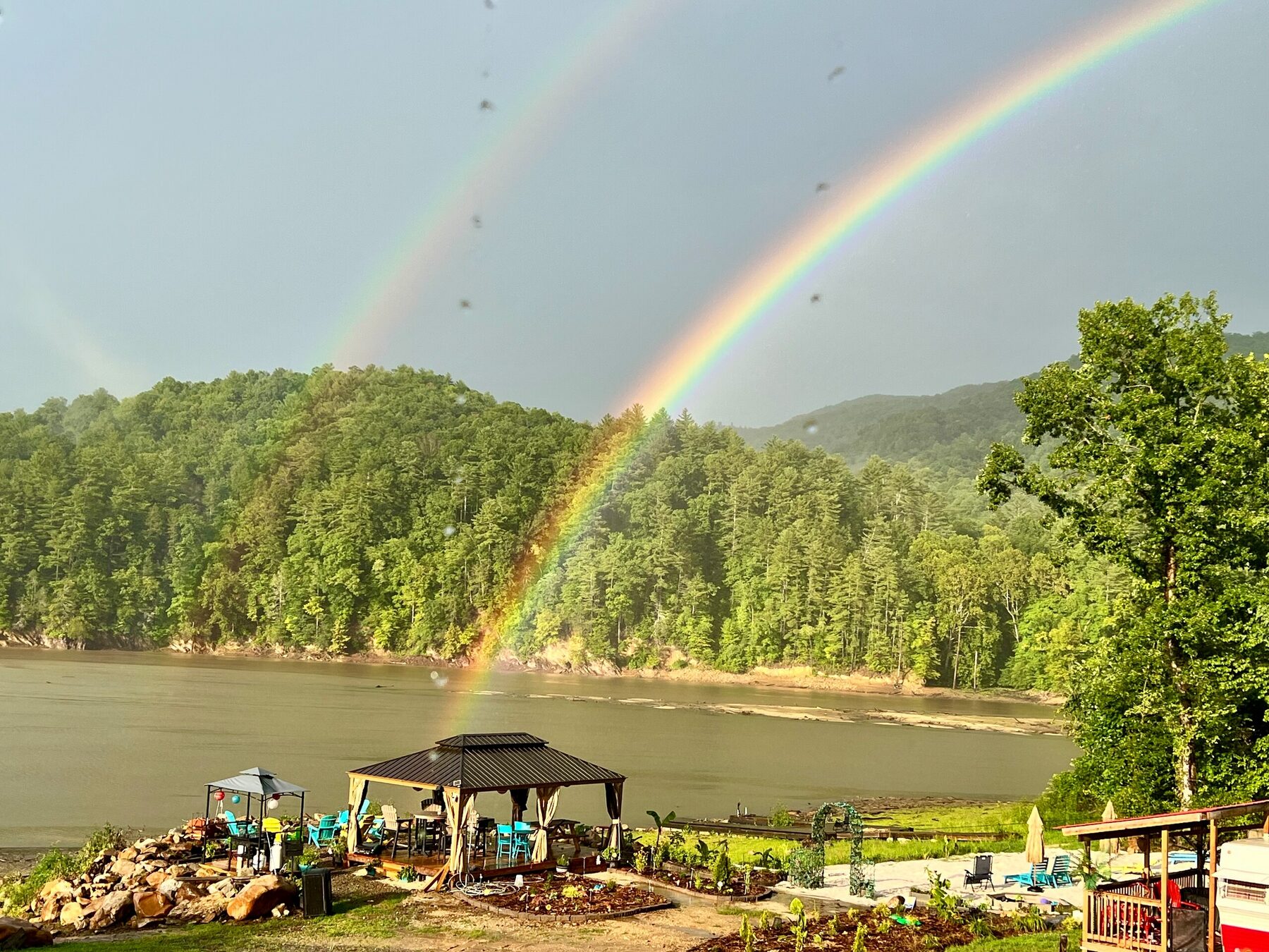 Double rainbow over the lake and the covered pavilion at Tn-Buc-Tu